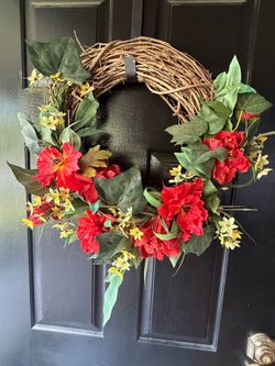 Wreath with red and yellow flowers, green leaves