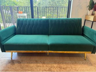 Green velvet couch with gold detailing