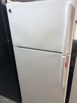 Used GE top and bottom fridge. 1 year warranty