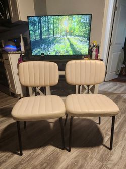 2 cream faux leather chairs