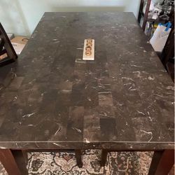Granite/Marble table with four chairs.