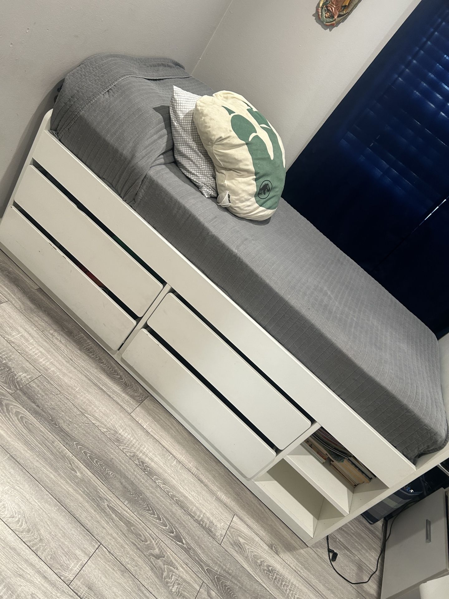 Twin bed with drawers, desk and white chair in excellent condition