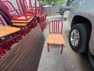 Sturdy red metal chairs with wooden seat.