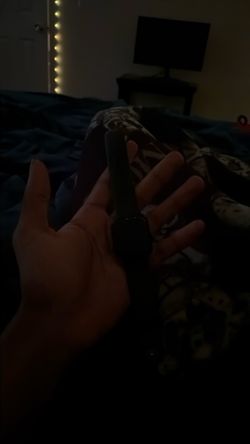 Black Apple watch with charger