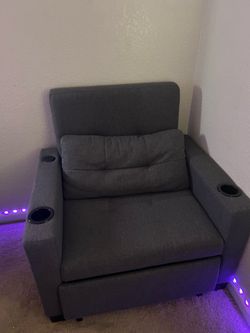 Grey reclining chair with cup holders and electric charger port