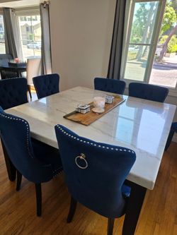 Solid marble table with 8 blue velvet dining chairs
