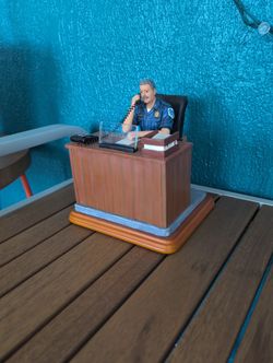 Blue Hats Of Bravery Police Chief Vanmark Police Figurine Sitting at Desk.