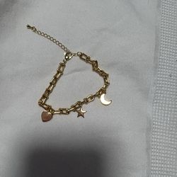 chain bracelet with stars, moon, and heart charms
