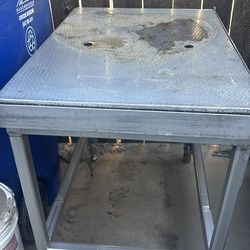 Stainless steel table with adjustable legs