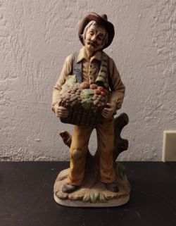 Old man farmer carrying fruit basket
