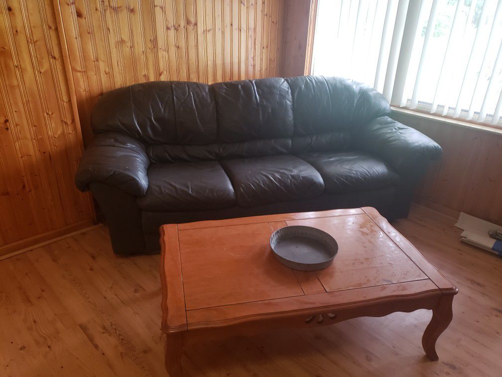 Leather couch and love seat and coffee table and a Desk