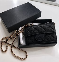 black quilted mini flap bag with gold chain. Comes with box.