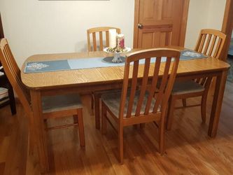 table and 4 chairs. Oak color. Expected wear to chair cushions. Dimensions include 15" leaf.