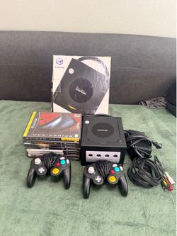 Nintendo GameCube with two controllers with eight games