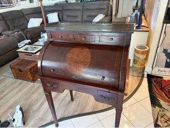 A Hepplewhite style mahogany roll-top secretary desk with cabriole legs.