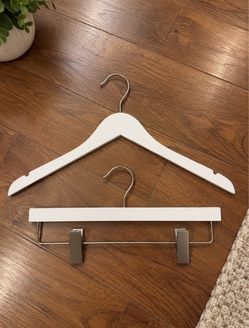 Set of 20 high-quality white wooden hangers in excellent condition.