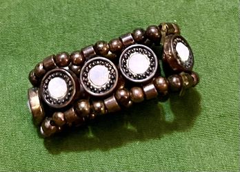 vintage-style beaded stretch ring, commonly categorized as a statement or cocktail ring due to its wide band and decorative medallions