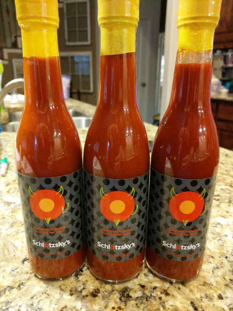 Three bottles of Schlotzsky's hot sauce unopened