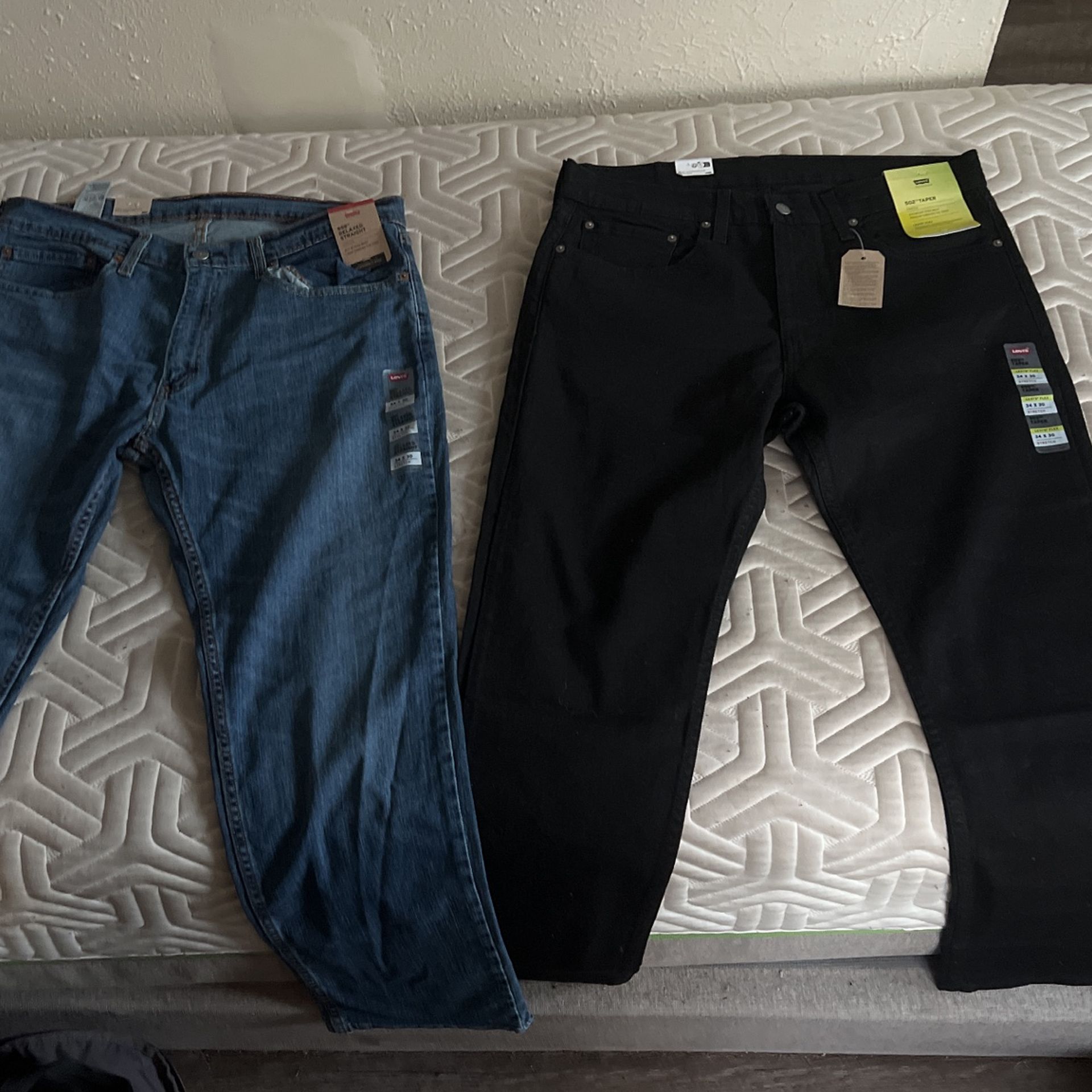 2 Levi’s Jeans 34 By 30 Brand New Good Condition. Black Levi 502 Taper/ Blue Levi 559 Relaxed Straight.