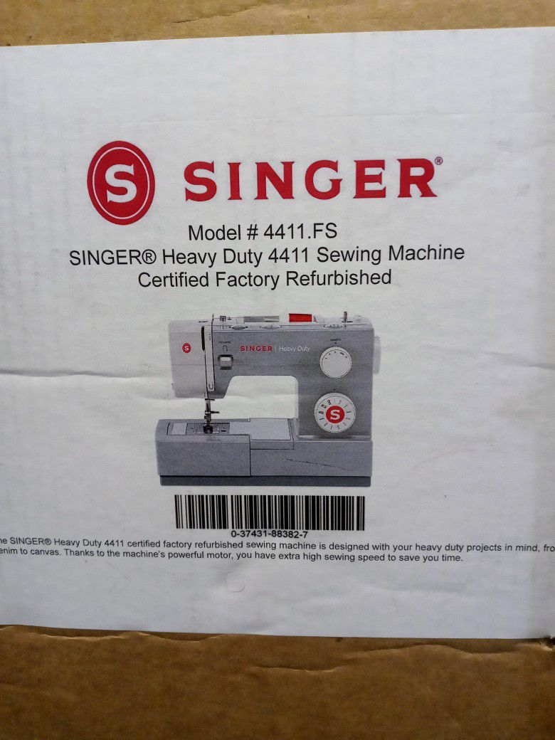 New Heavy Duty Singer Sewing Machine With Cutting Board And A Large Roll Of Fabric