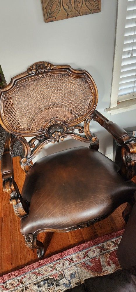 Elegant Upholstered Chair with Cane Back and Padded Arms