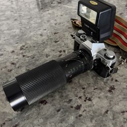 Cannon AE-1 Camera + 50mm Zoom Lens  w/flash and Case