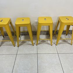 4 Yellow Metal Stools