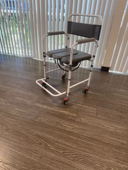 $55 / New - Bedside Commode-Shower chair with wheels and bucket / 300 pound capacity