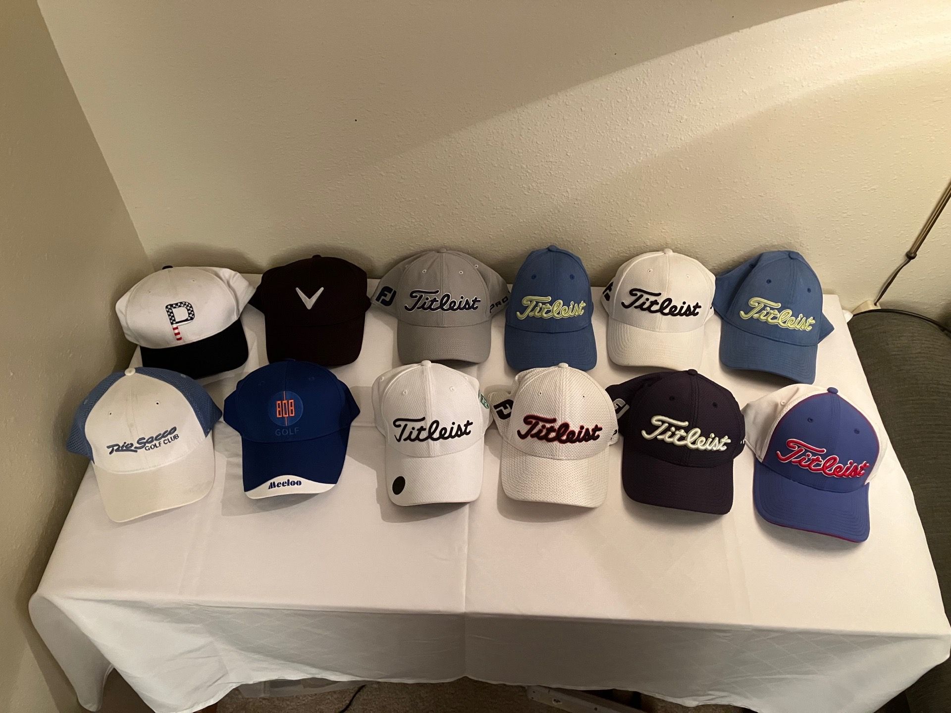 Large collection of golf hats