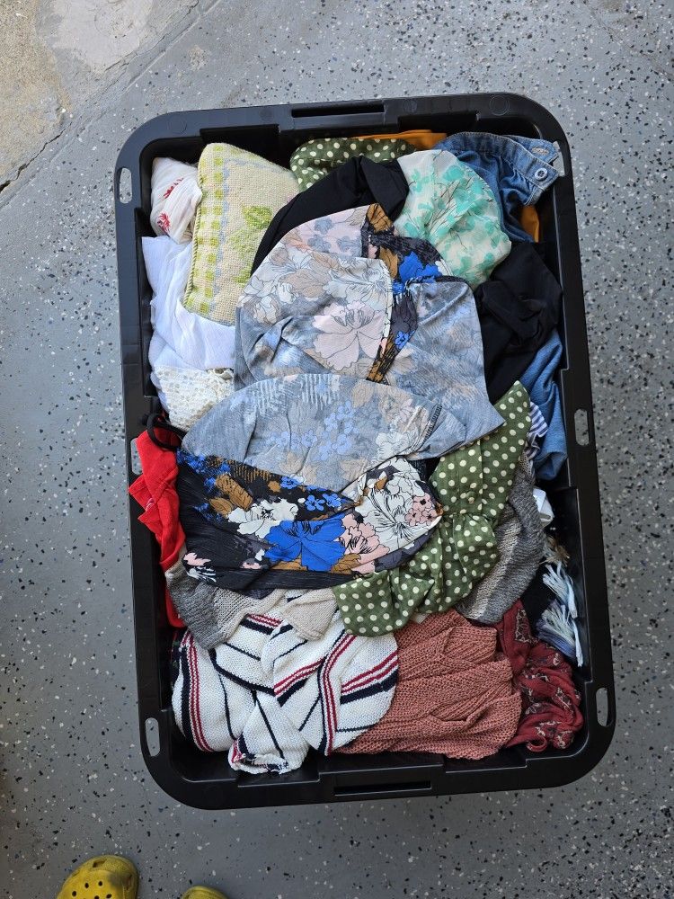 Containers of new with tags and gently used Women's clothes