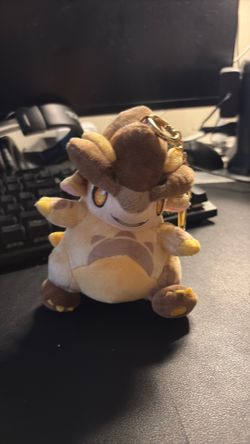official Genshin Impact Natlan Tepetlisaurus (Baby Saurian) plush keychain.