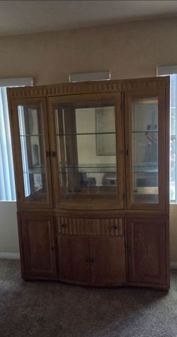 Wood China Cabinet with Glass Doors and table with chairs.