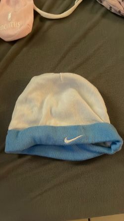 Baby clothes one baby clothes and a couple of baby girls clothes little things so they won’t scratch herself socks, a hat,