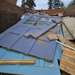 free random wood with nails from demo and cut doors with windows.  

going to the dump soon