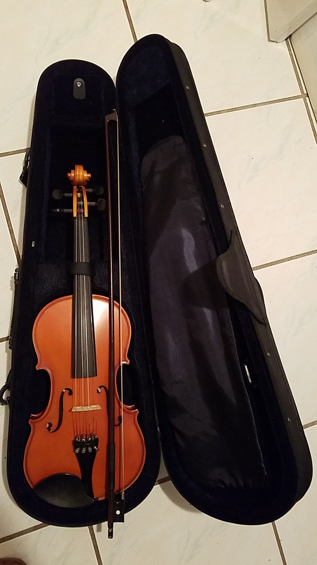 Violin with bow, case and sheet music