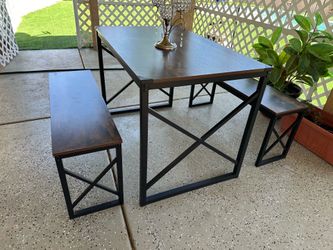 A modern dining set featuring a table and two matching chairs; in like-new condition.