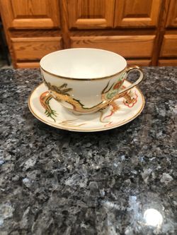 Cup & Saucer Set.  Preowned Excellent Condition No Cracks Or Chips .  Size saucer 5 inches wide and cup 2 1/2 inches by 2 1/2 inches.  Has been on dis