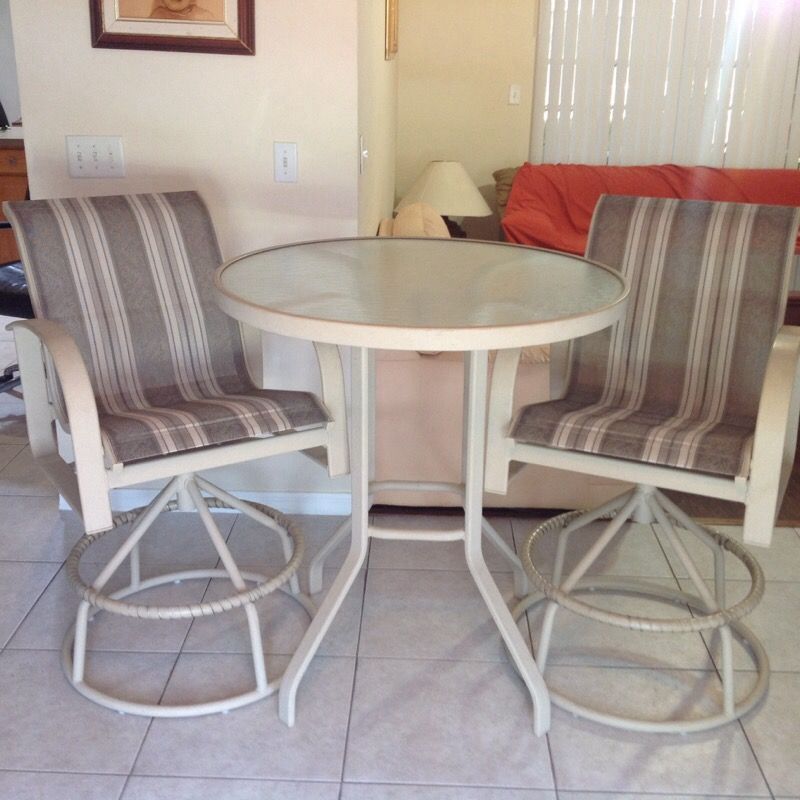 Patio high top table and two swivel top bar stools in like new condition