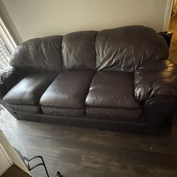 Brown Leather Couch And Love Seat. With 2small And 1 Big Table 