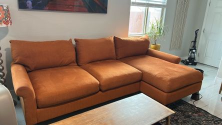 Orange 9 foot couch with chase