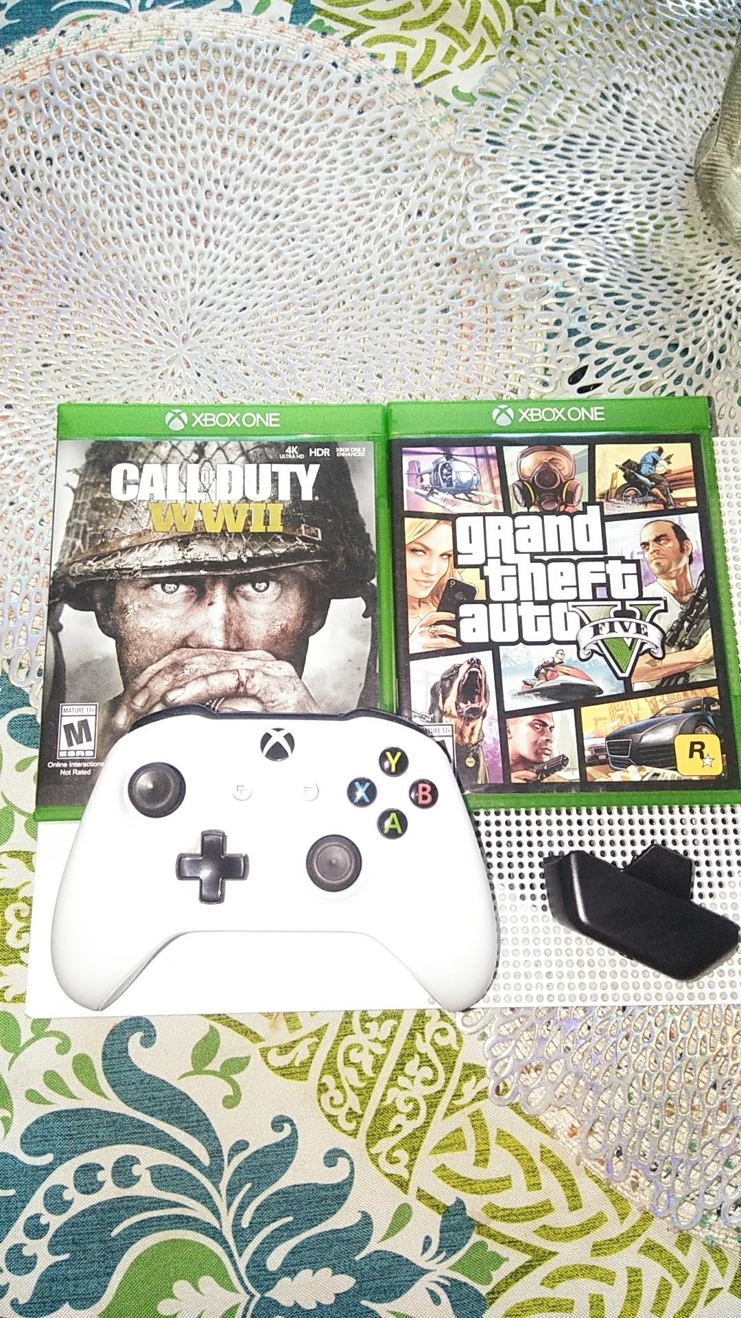 Xbox one with two games and with headphones plug gaming controls with power cables and HDMI cable