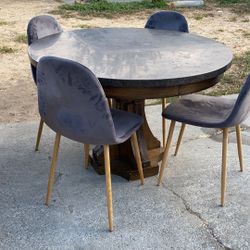 Black round marble table with 4 gray modern chairs