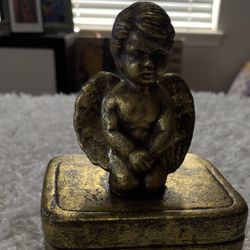 vintage, gold-toned trinket box featuring a angel figure on top from the 1970s.