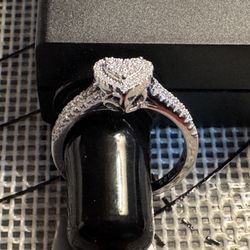 This is a modern .925 Silver Moissanite Heart-shaped cluster ring.