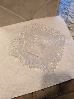 vintage Indiana Glass diamond point candy dish featuring a ruffled edge and a geometric diamond pattern.