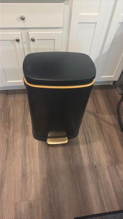 Black and gold trash can