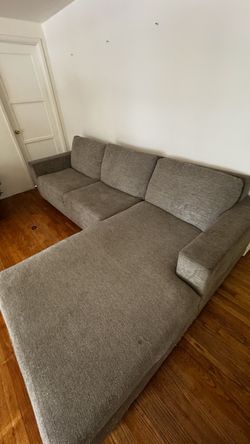 Gray sectional with Ottoman with pull out bed