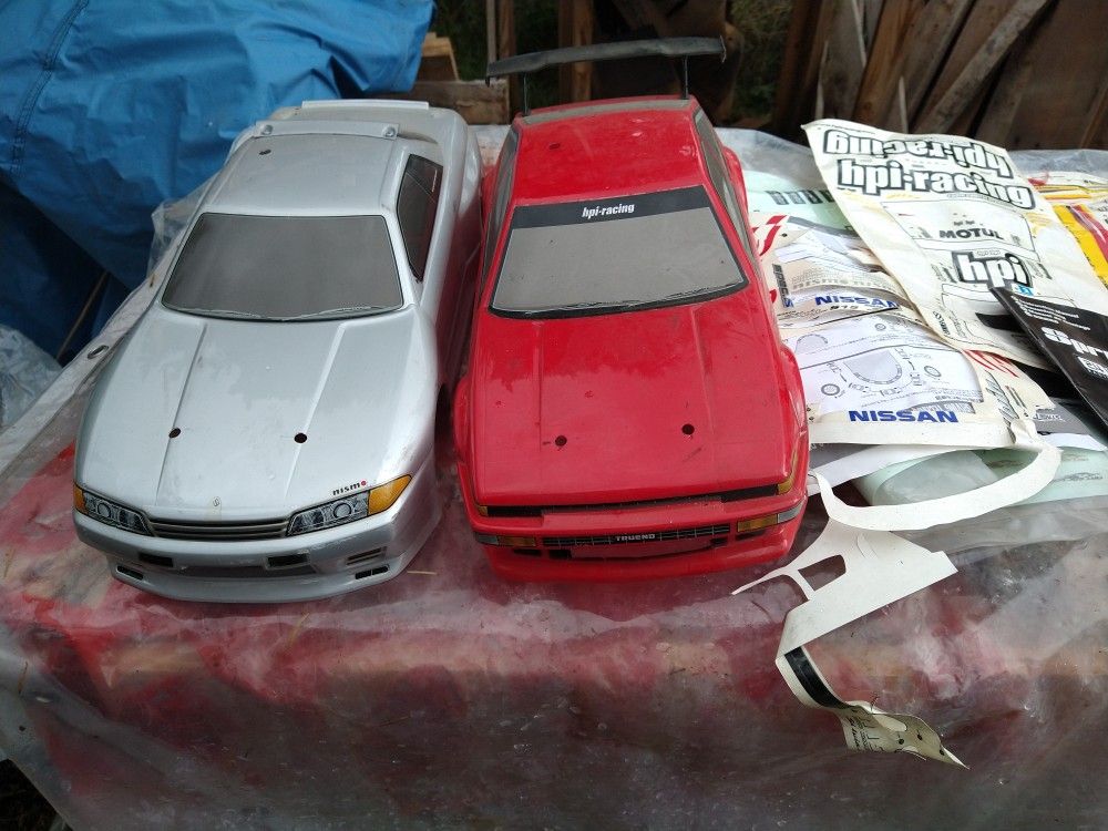 2 Complete HPI-Racing Car's. Chassis Bodies, Several Tires, 2 Electric Motors. 1 Controller.