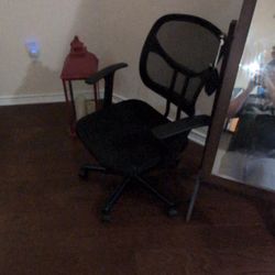 Comfortable black office chair with mesh back and padded seat.