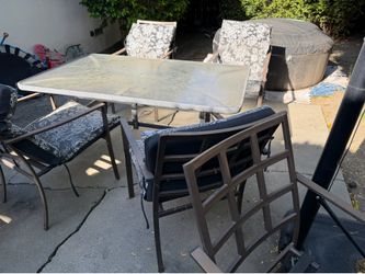Patio table with chairs and grill